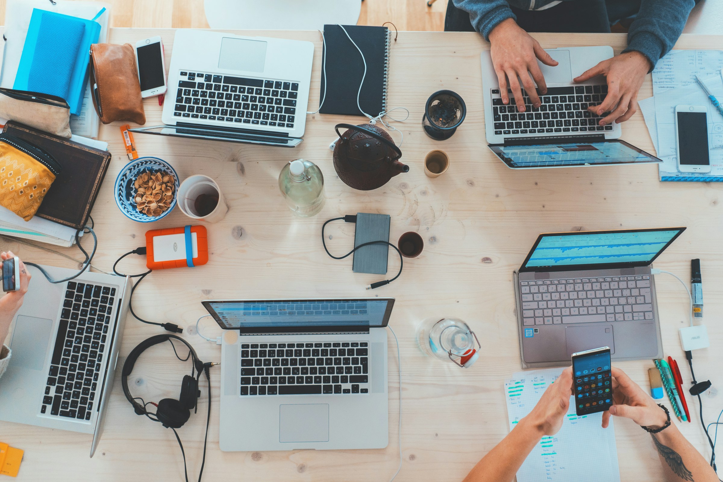 Laptops and notebooks on a collaborative worktable